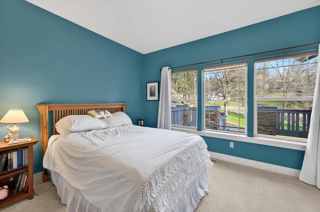 a bedroom with a large bed and a large window