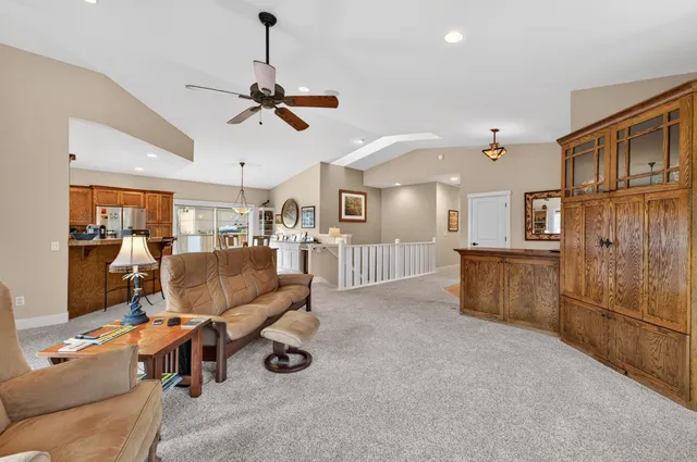a living room with furniture and kitchen view