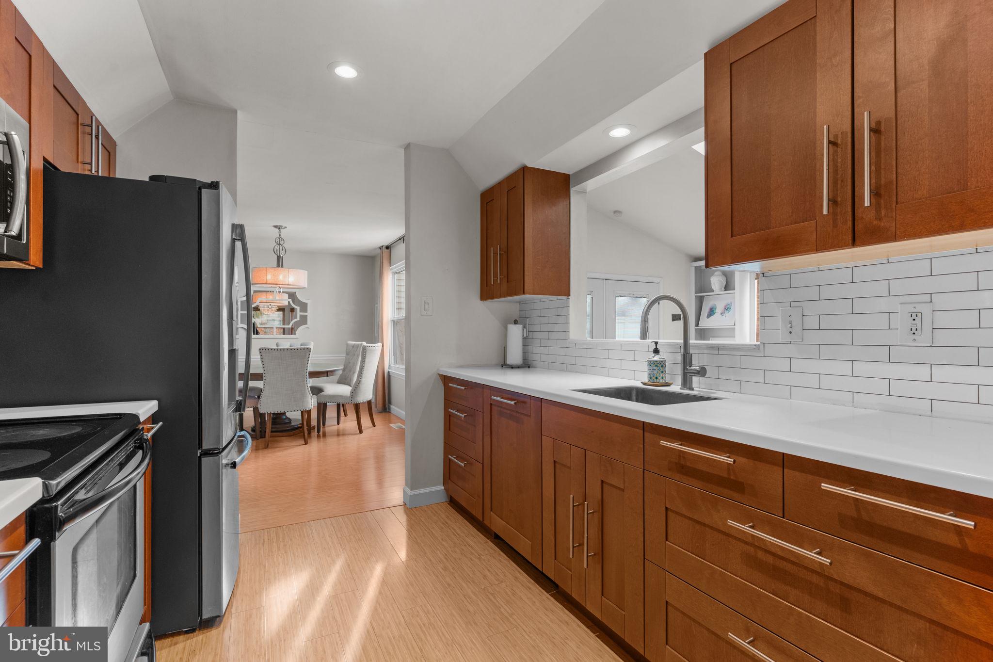 105 South Timber Road Holland, PA 18966 - Photo 11 of 34 a kitchen with stainless steel appliances sink stove refrigerator and cabinets