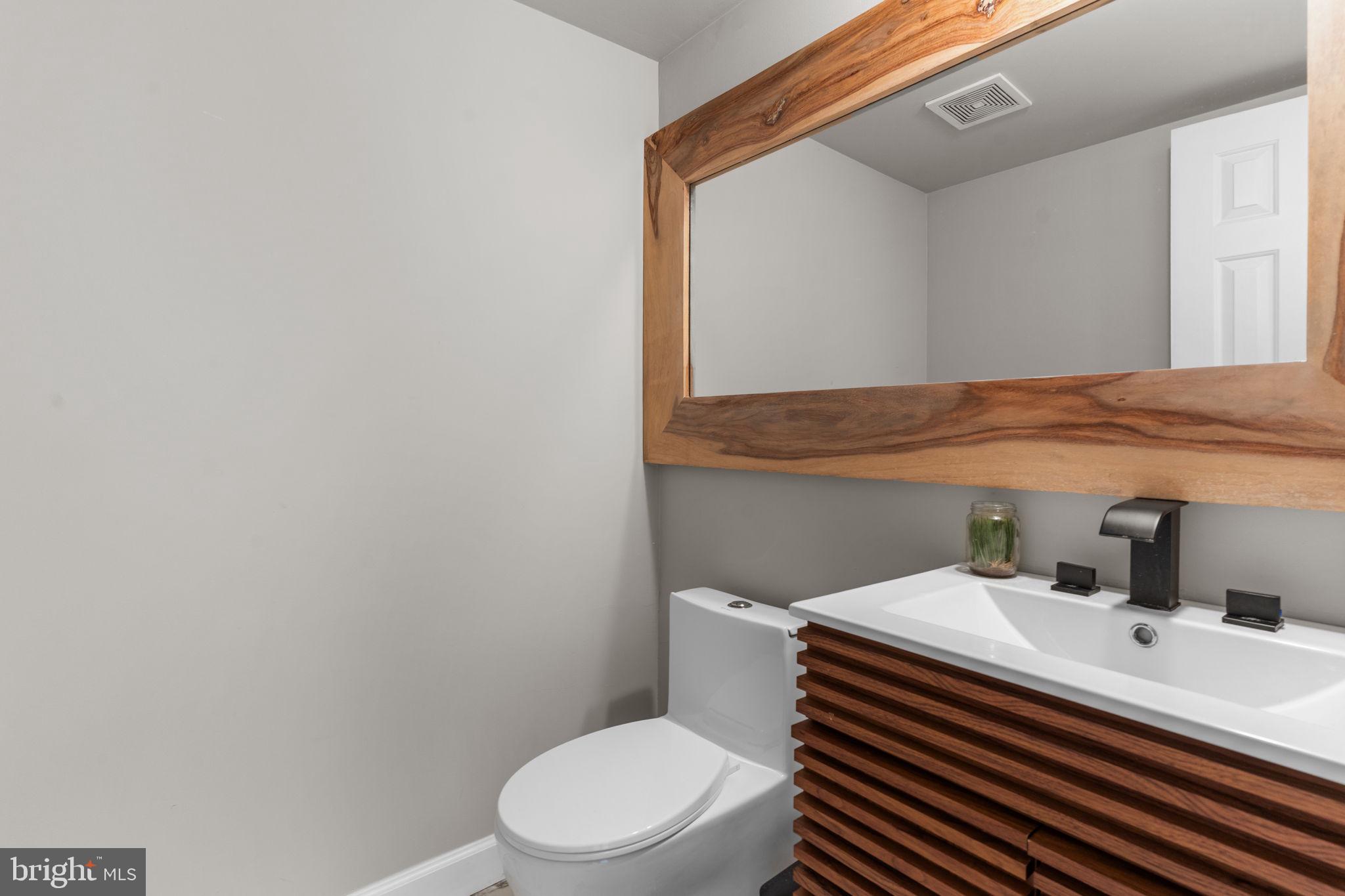 105 South Timber Road Holland, PA 18966 - Photo 17 of 34 a bathroom with a sink a toilet and mirror