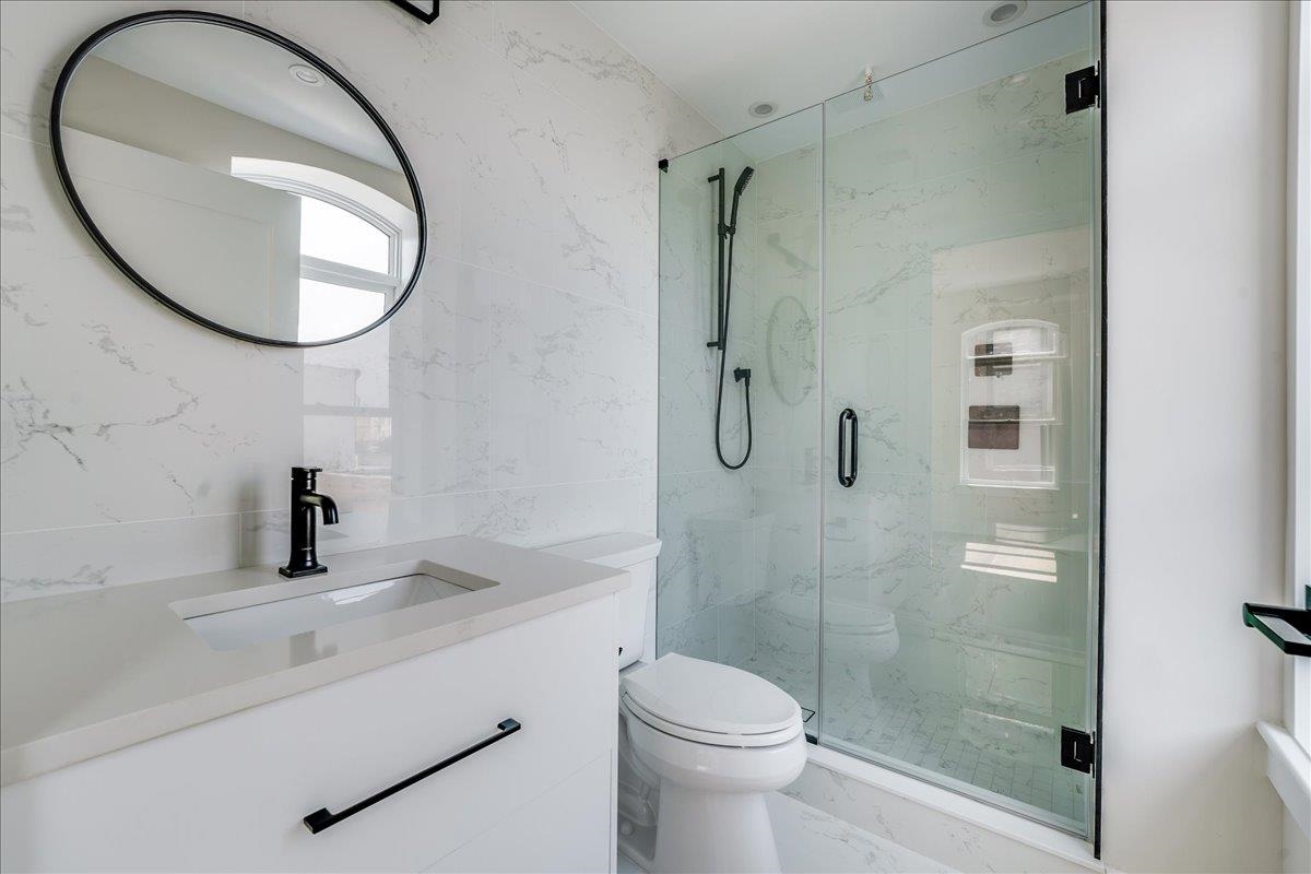 237 Washington Street, Unit 204 Hoboken, NJ 07030 - Photo 14 of 34 a bathroom with a sink a toilet and a mirror