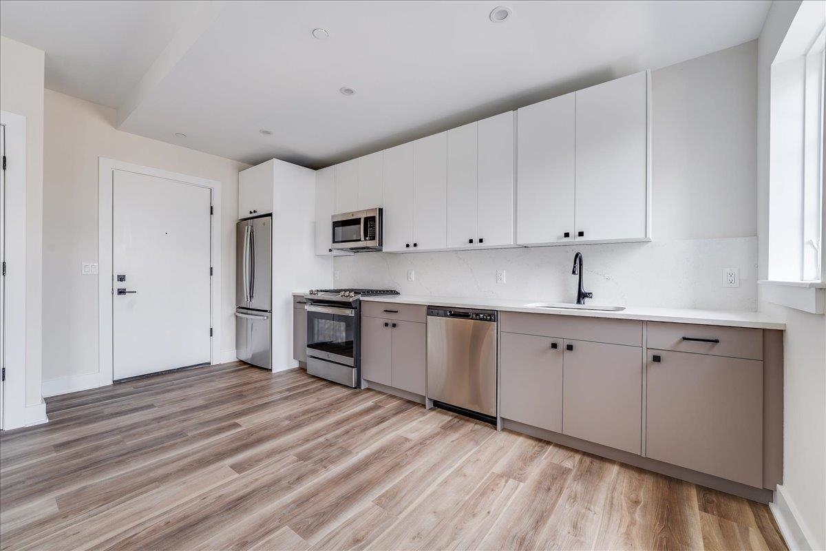 237 Washington Street, Unit 204 Hoboken, NJ 07030 - Photo 3 of 34 a kitchen with appliances cabinets and a sink