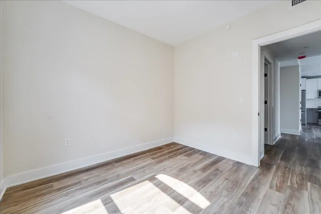 a view of a room with wooden floor