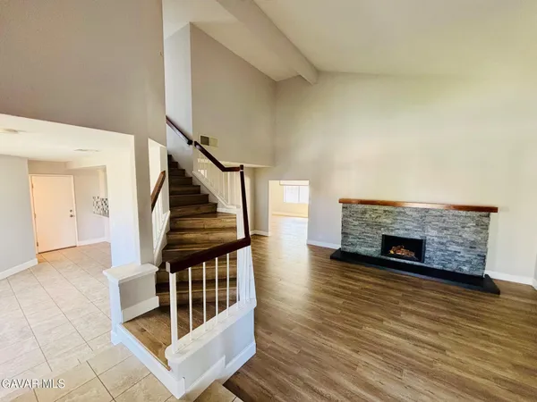 a view of staircase with wooden floor and a fireplace
