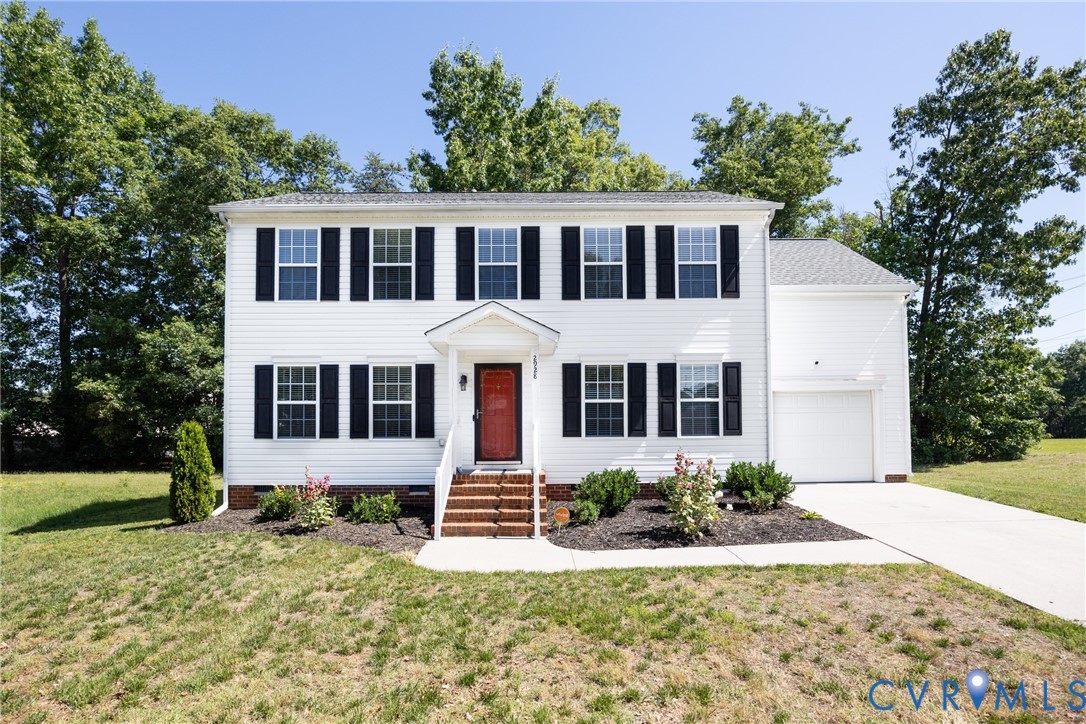 Two-story white siding exterior with a red front d