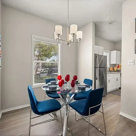a dining room with furniture and window