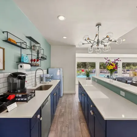 a kitchen with lots of counter top space a sink and wooden floor