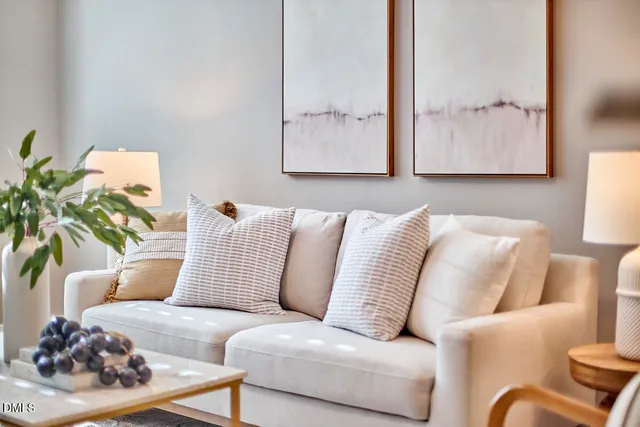 a living room with furniture and a lamp