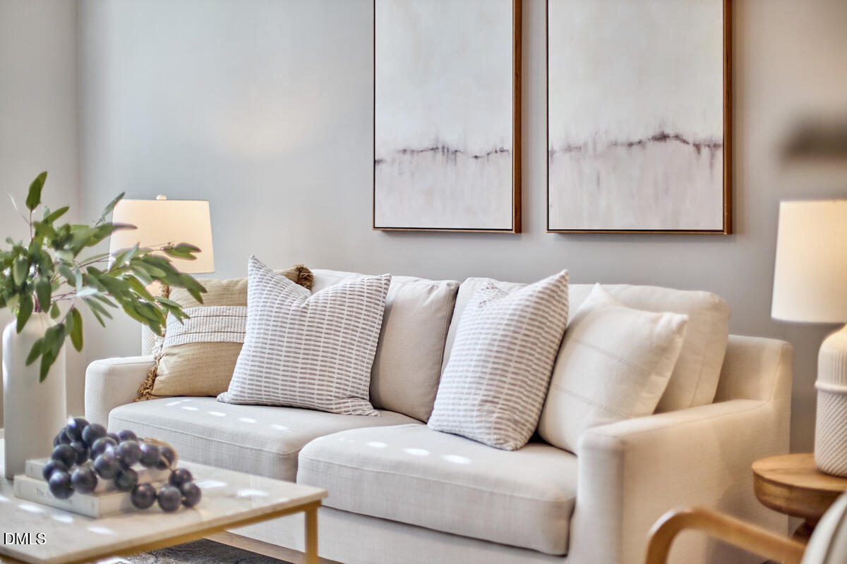 a living room with furniture and a lamp