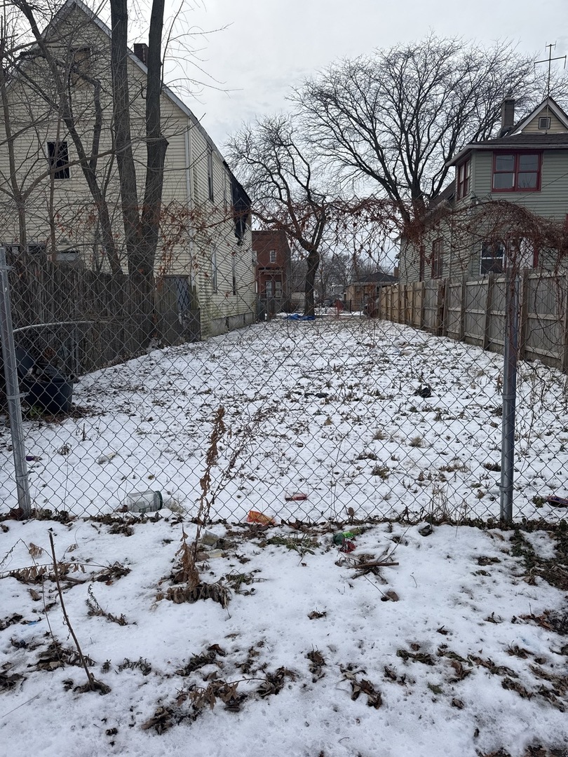 12017 South Wallace Street Chicago, IL 60628 - Photo 2 of 3 a view of a yard covered in snow