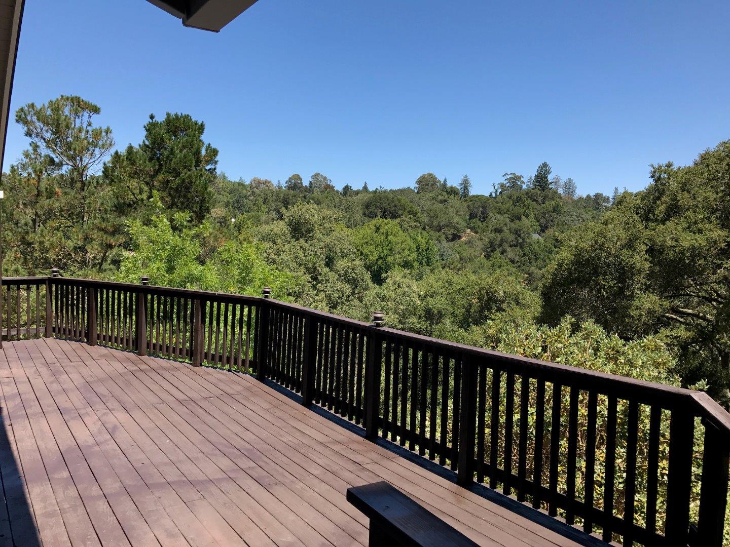 a balcony with wooden floor and fence