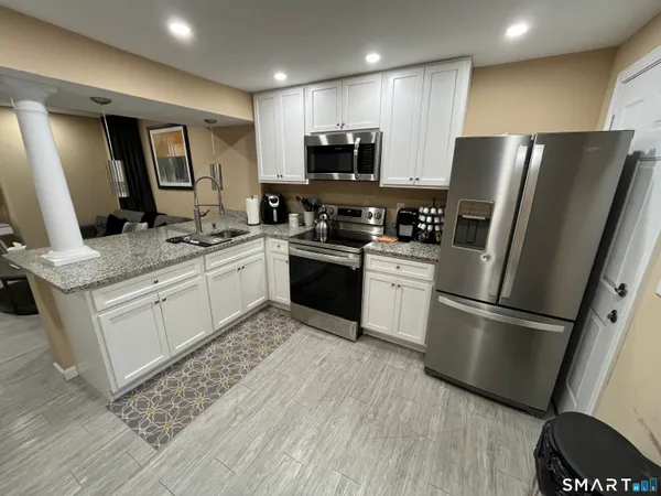 a kitchen with a sink stainless steel appliances and refrigerator