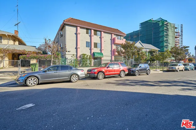 a view of a cars is parked in front of a building