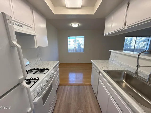 a kitchen that has a sink and a stove