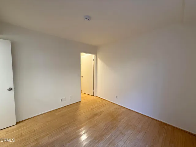 a view of an empty room and wooden floor
