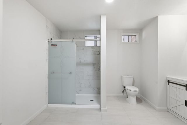 a bathroom with a toilet and a shower