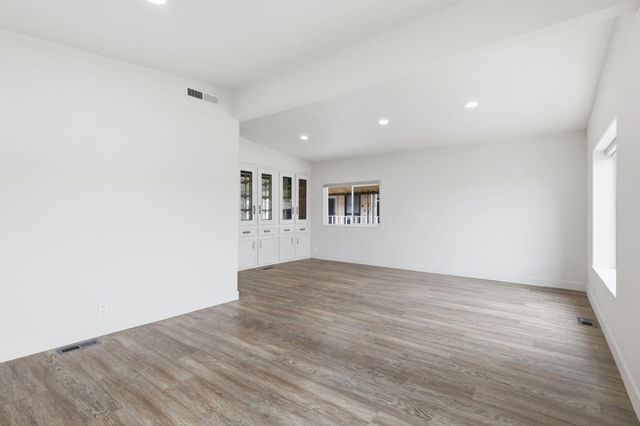 a view of wooden floor and windows in a room