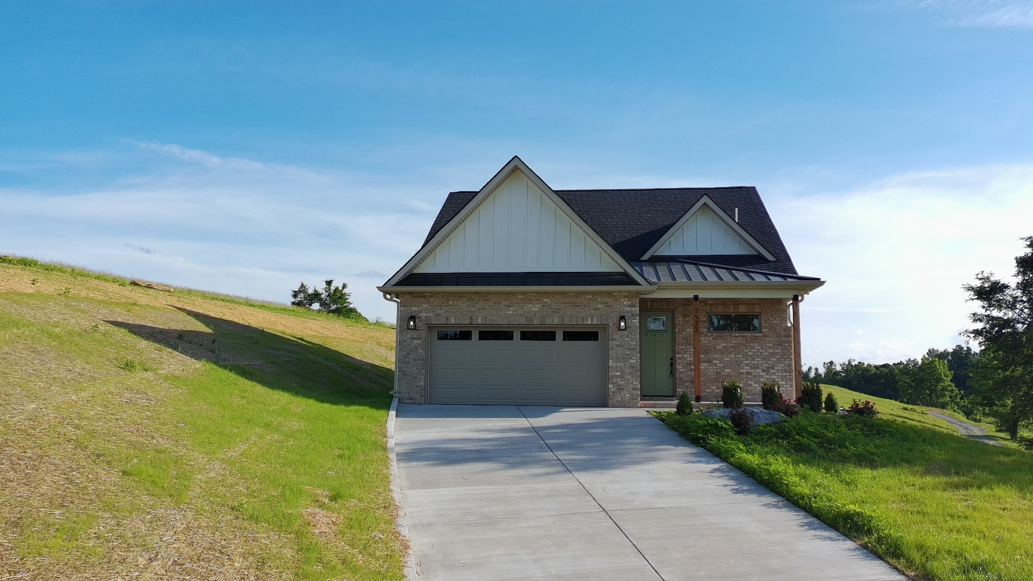 2953 Wixtown Road Westmoreland, TN 37186 - Photo 3 of 35 a front view of a house with a garden and yard