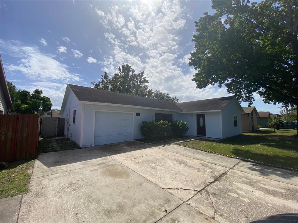 7628 Ruthwind Court Orlando, FL 32822 - Photo 1 of 1 a front view of house with yard and trees