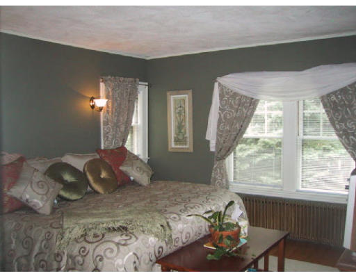 42 Harland Road Waltham, MA 02453 - Photo 4 of 6 a bedroom with a bed and a large window