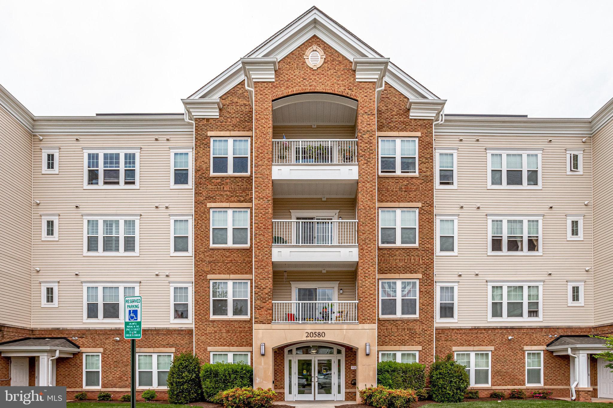 20580 Hope Spring Terrace, Unit 207 Ashburn, VA 20147 - Photo 2 of 61 a front view of a residential apartment building with a lot of windows