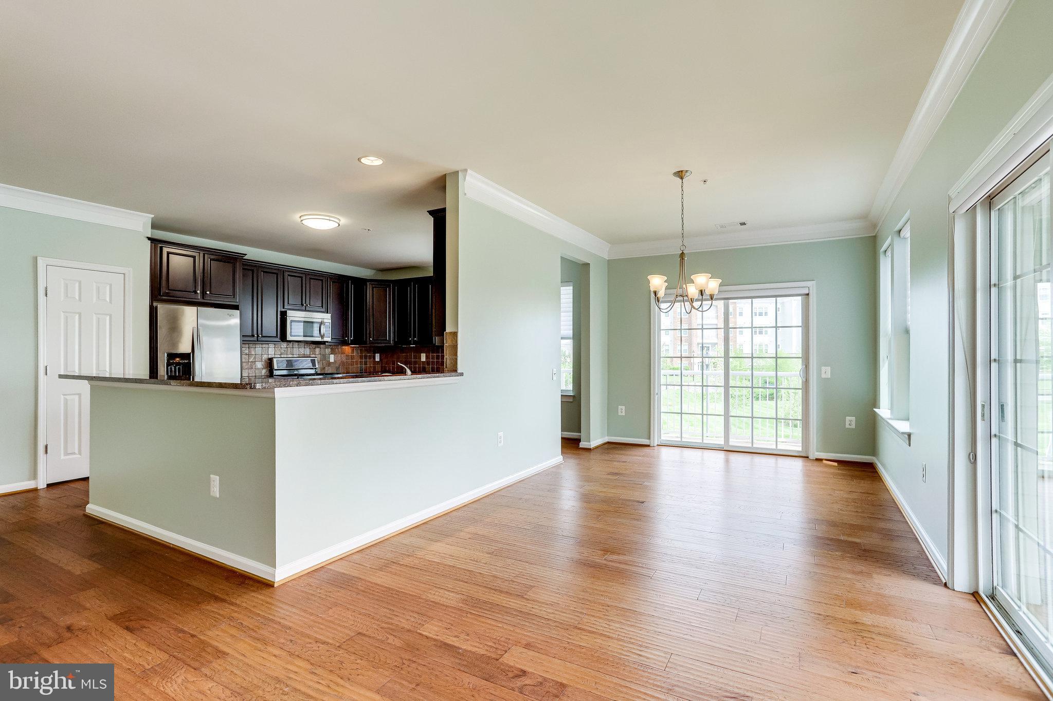 20580 Hope Spring Terrace, Unit 207 Ashburn, VA 20147 - Photo 12 of 61 a view of a kitchen with furniture and wooden floor