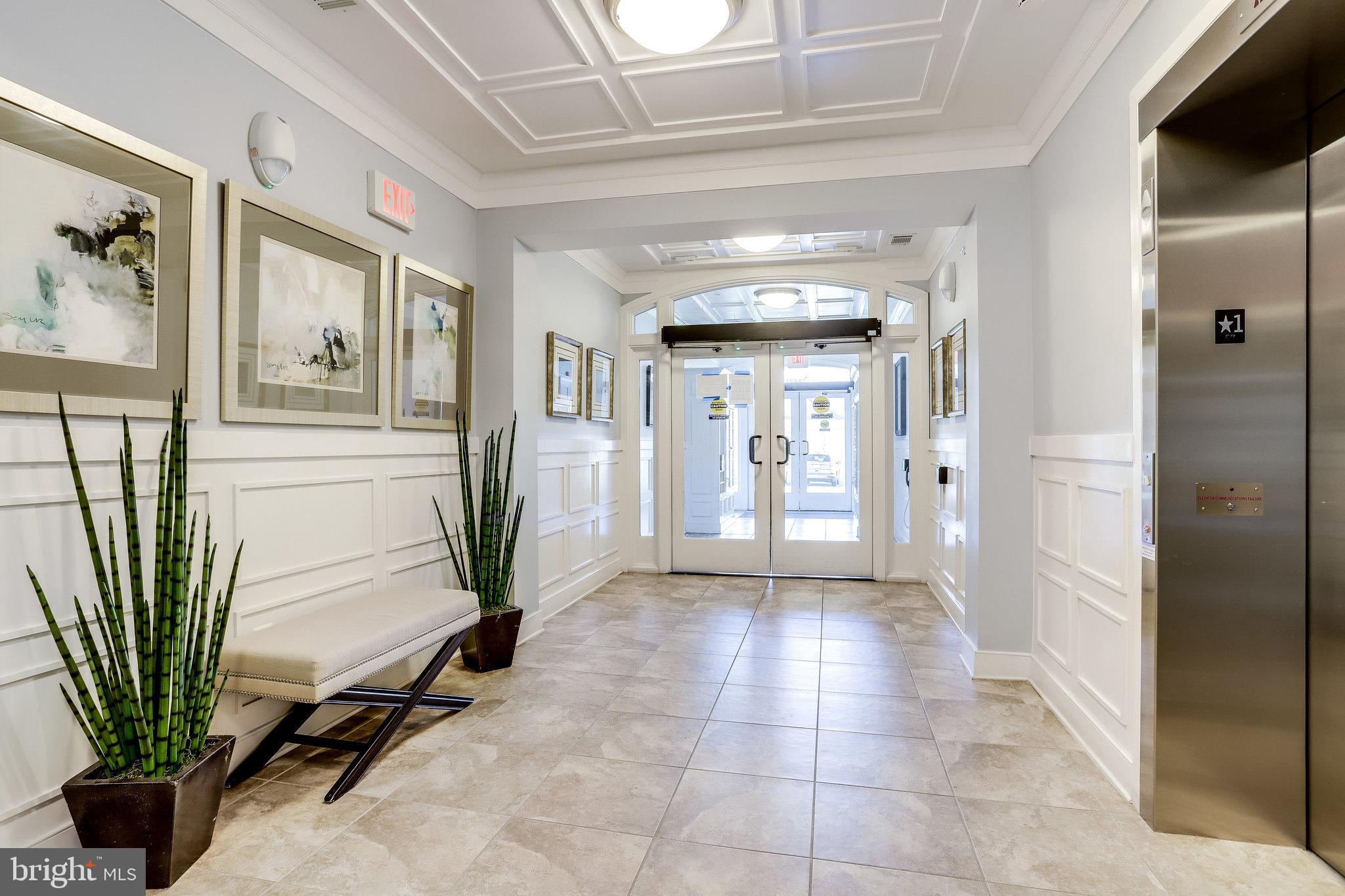 20580 Hope Spring Terrace, Unit 207 Ashburn, VA 20147 - Photo 3 of 61 a view of a hallway with a entryway