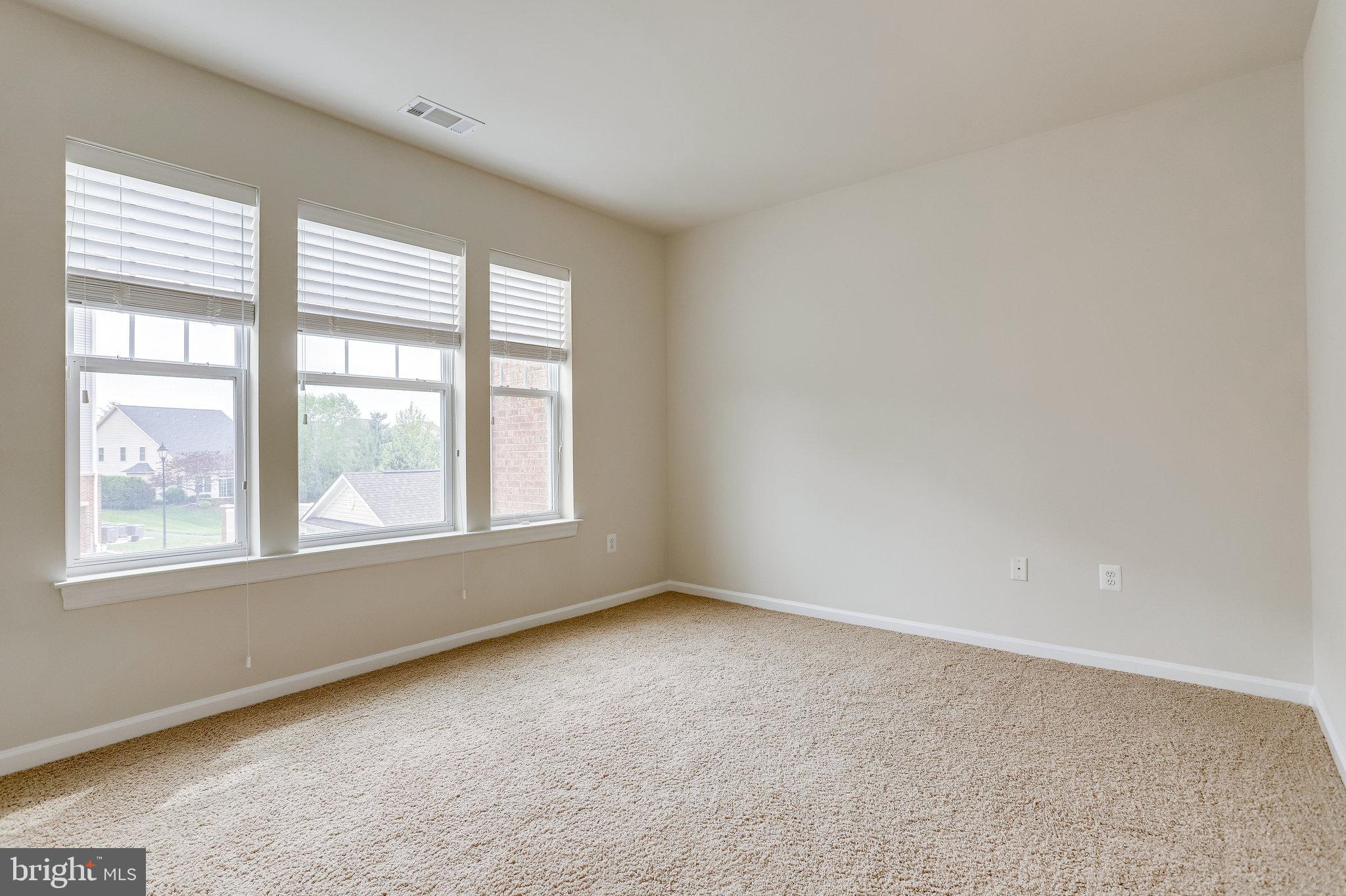 20580 Hope Spring Terrace, Unit 207 Ashburn, VA 20147 - Photo 25 of 61 an empty room with a window