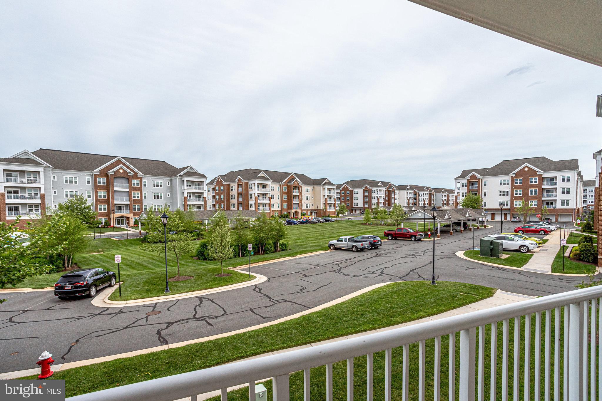 20580 Hope Spring Terrace, Unit 207 Ashburn, VA 20147 - Photo 32 of 61 a view of a city from a cars park in front of a brick house