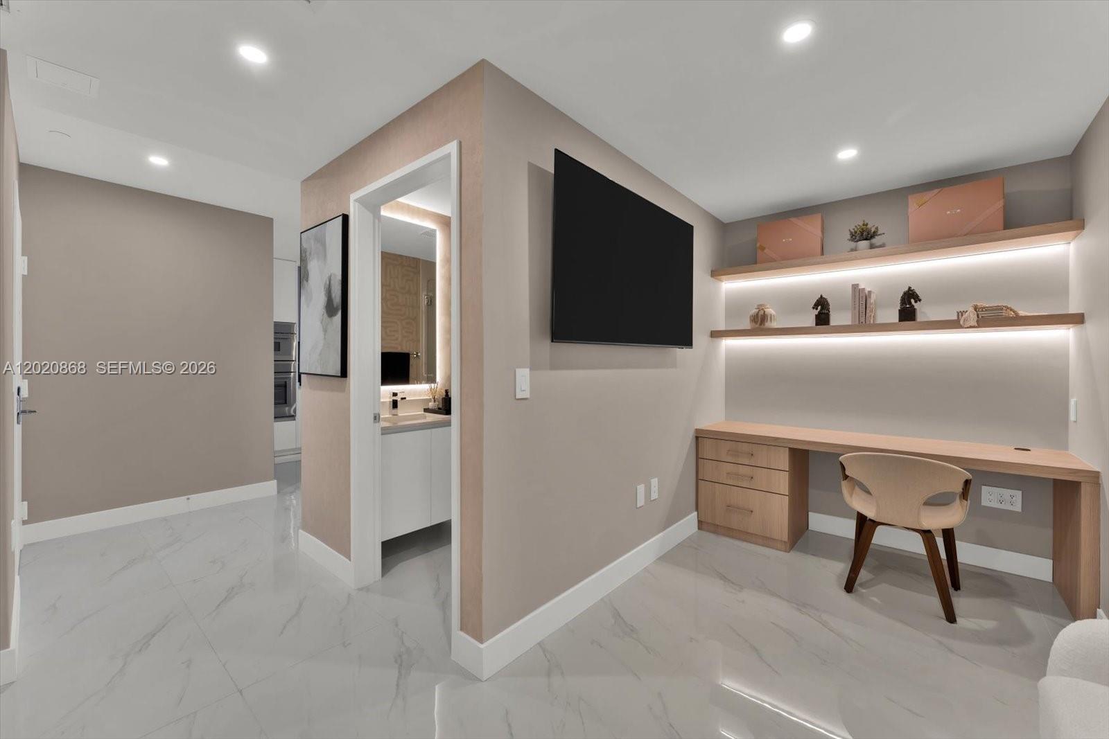700 Northeast 24th Street, Unit 1602 Miami, FL 33137 - Photo 18 of 30 a hallway with furniture a refrigerator and a flat screen tv