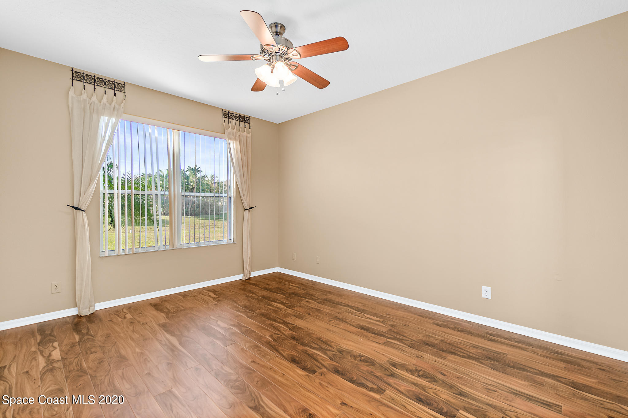 153 Babylon Lane Melbourne, FL 32903 - Photo 19 of 32 a view of an empty room with a window