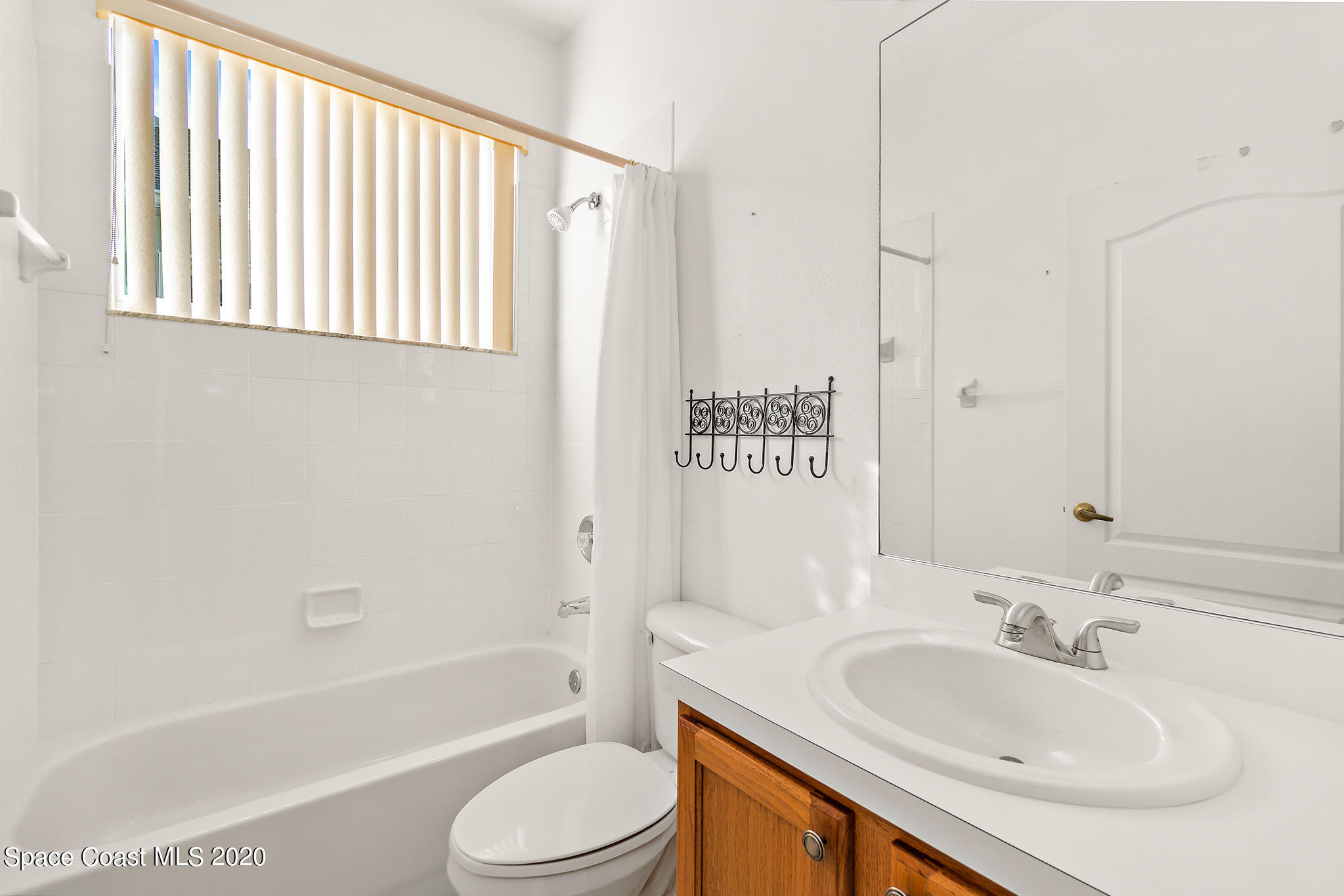 153 Babylon Lane Melbourne, FL 32903 - Photo 25 of 32 a bathroom with a sink toilet and shower