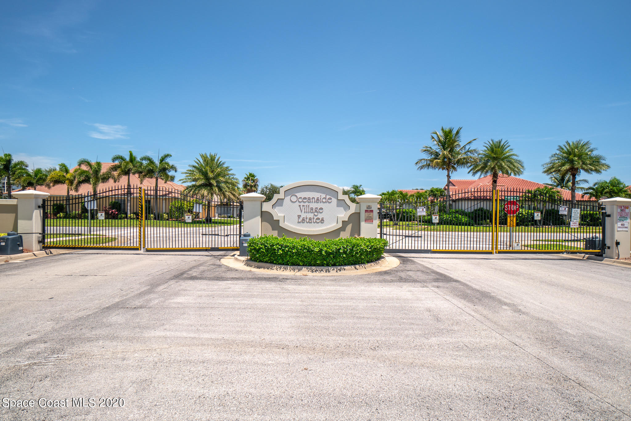 153 Babylon Lane Melbourne, FL 32903 - Photo 27 of 32 a view of a park with a bench and trees in the background