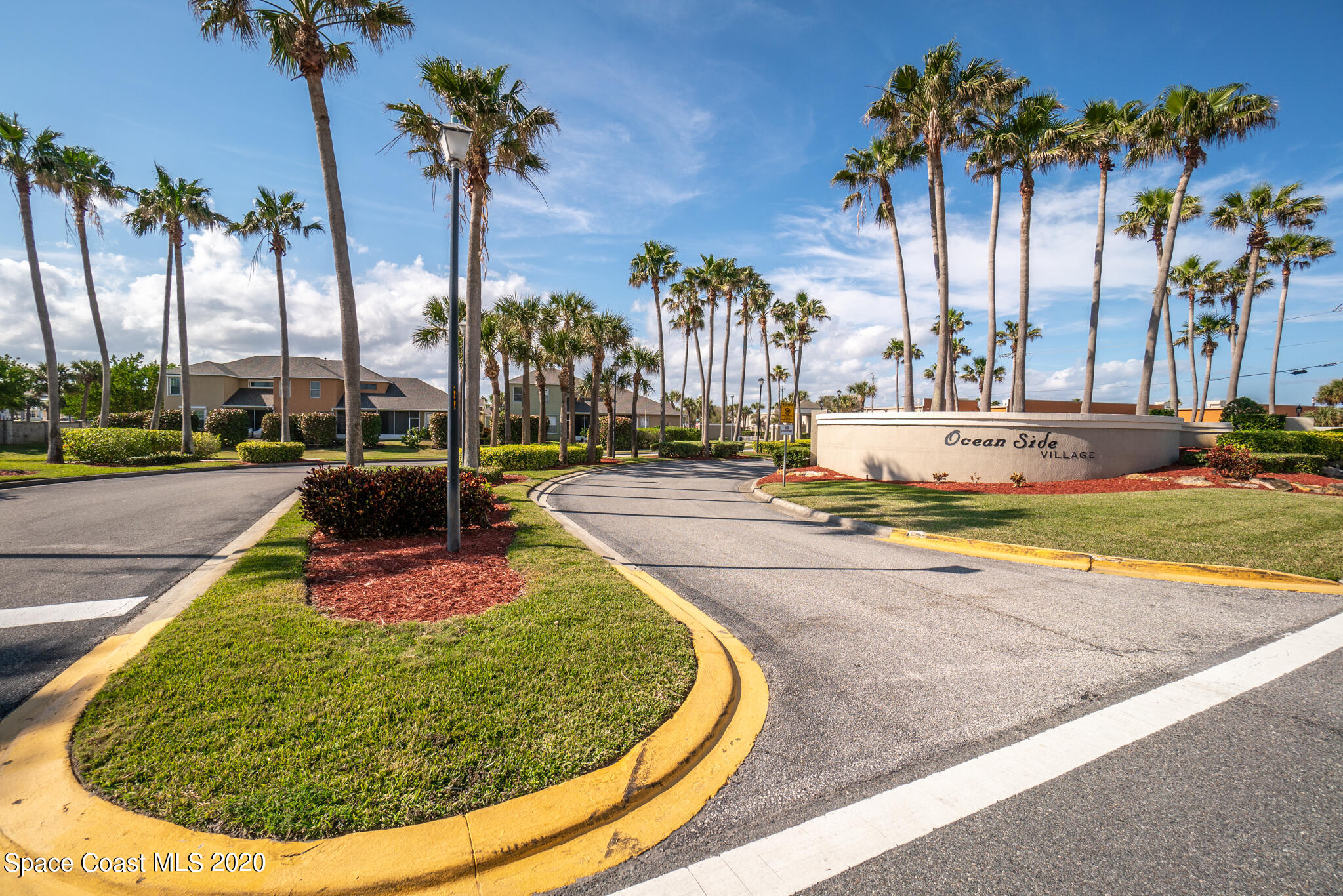 153 Babylon Lane Melbourne, FL 32903 - Photo 30 of 32 a view of a swimming pool with a yard and palm trees