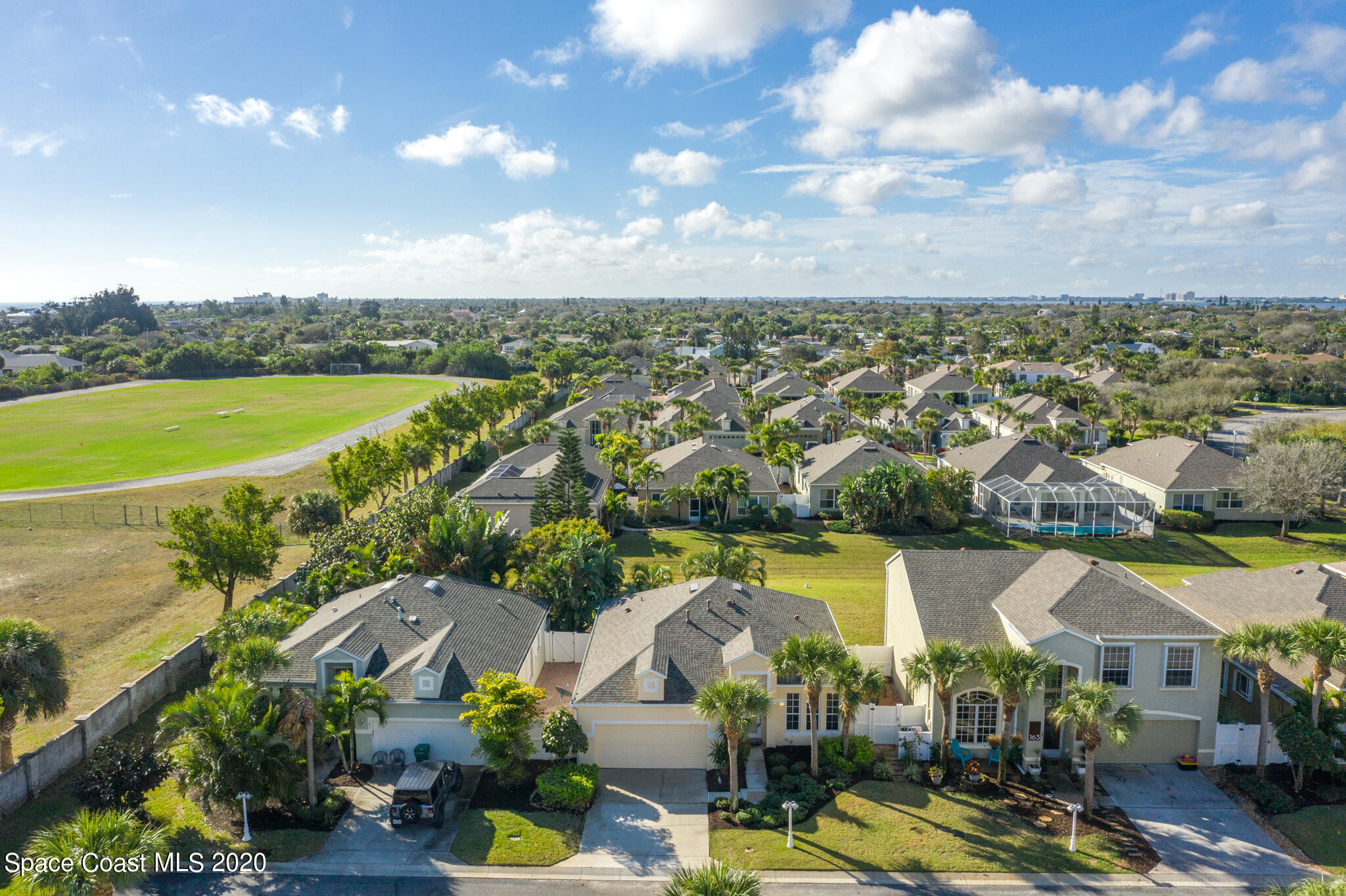 153 Babylon Lane Melbourne, FL 32903 - Photo 8 of 32 an aerial view of residential houses with outdoor space and lake view