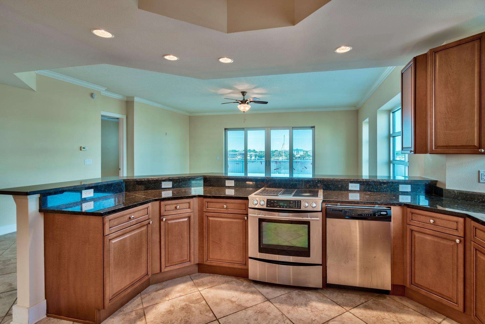 211 Durango Road, Unit 317 Destin, FL 32541 - Photo 11 of 47 a kitchen with stainless steel appliances granite countertop a sink and cabinets