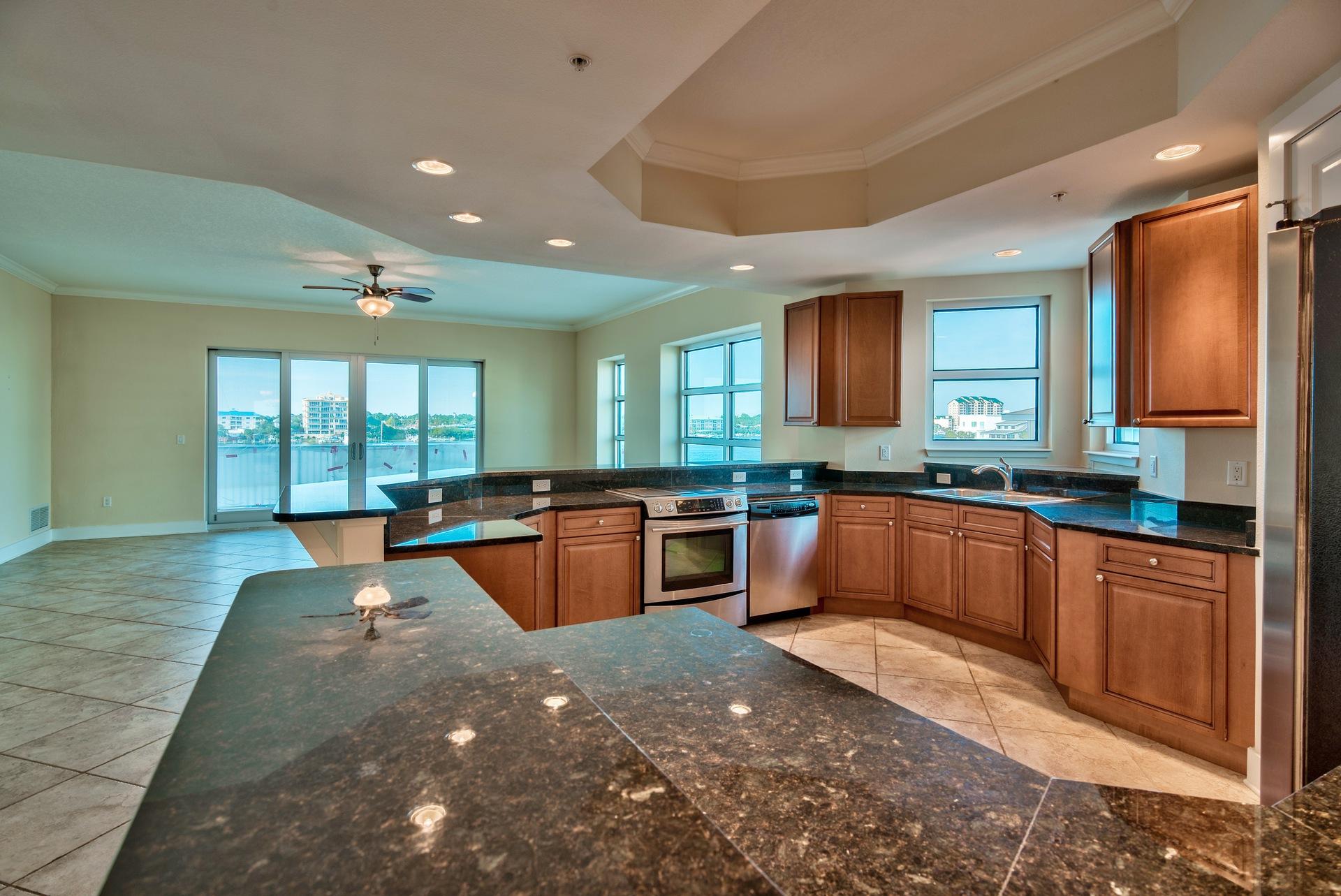 211 Durango Road, Unit 317 Destin, FL 32541 - Photo 12 of 47 a large kitchen with stainless steel appliances kitchen island granite countertop a large window