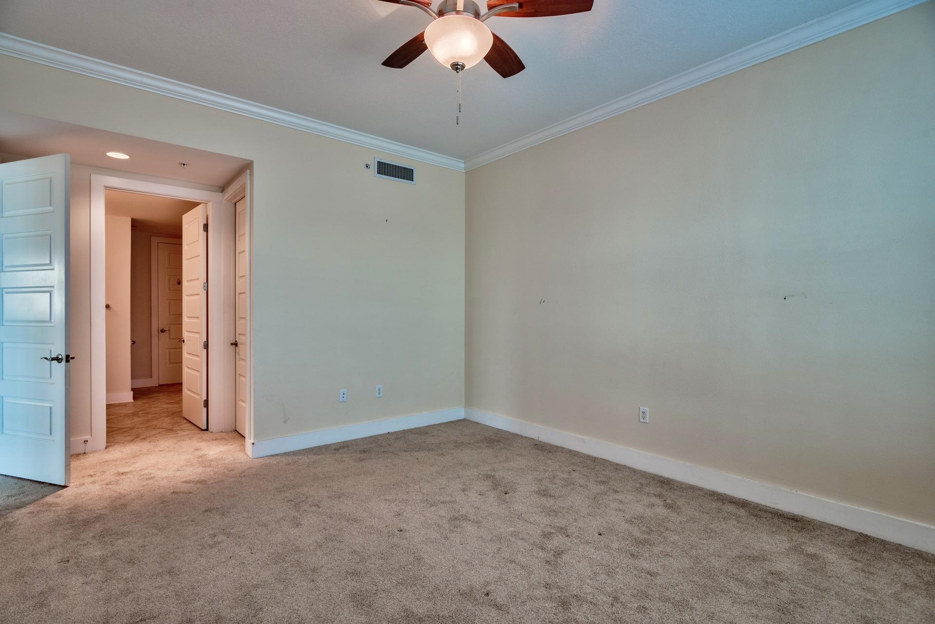 211 Durango Road, Unit 317 Destin, FL 32541 - Photo 16 of 47 an empty room with a ceiling fan and carpet