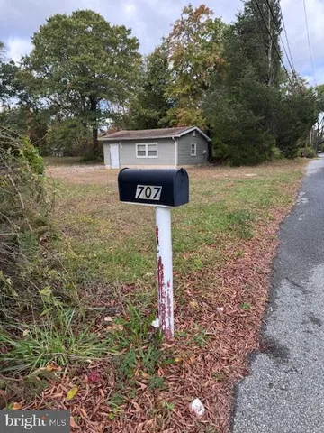 a sign board with yard in front of it