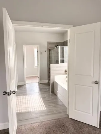 an empty room with a ceiling fan and windows