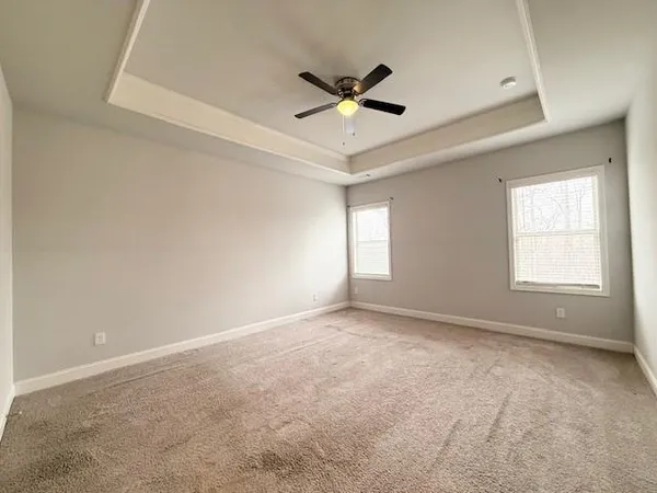 a spacious bathroom with a double vanity sink a mirror and a bathtub
