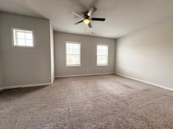 a view of a house with backyard and trees