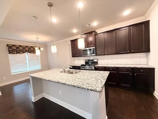 a view with kitchen island a sink wooden floor and a refrigerator