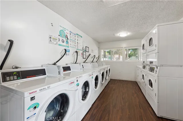 a view of washer and dryer with kitchen in the background