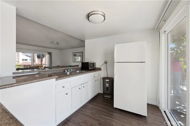 a kitchen with cabinets and stainless steel appliances