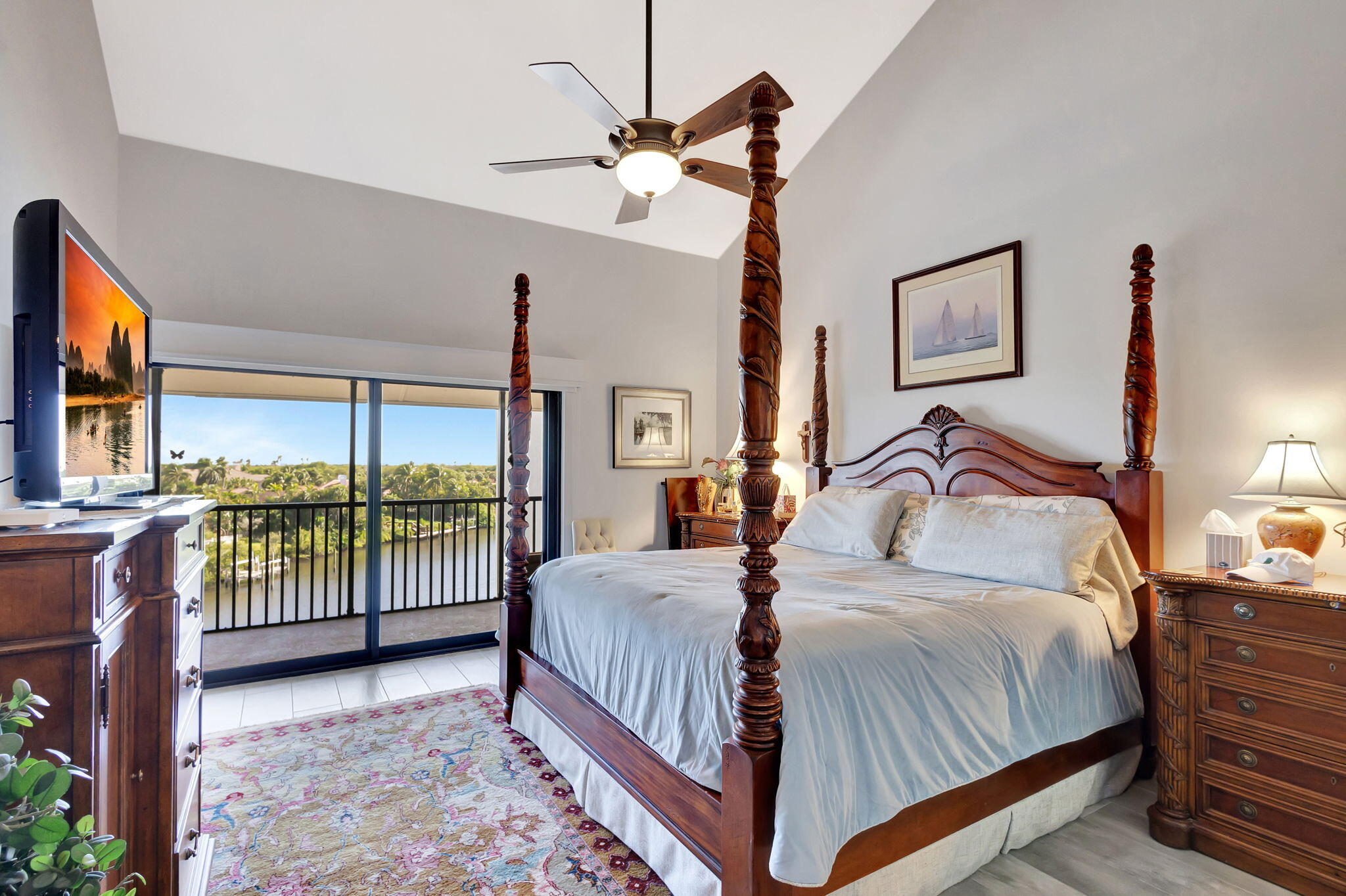 16910 Bay Street, Unit E503 Jupiter, FL 33477 - Photo 14 of 33 a bedroom with a bed and a ceiling fan