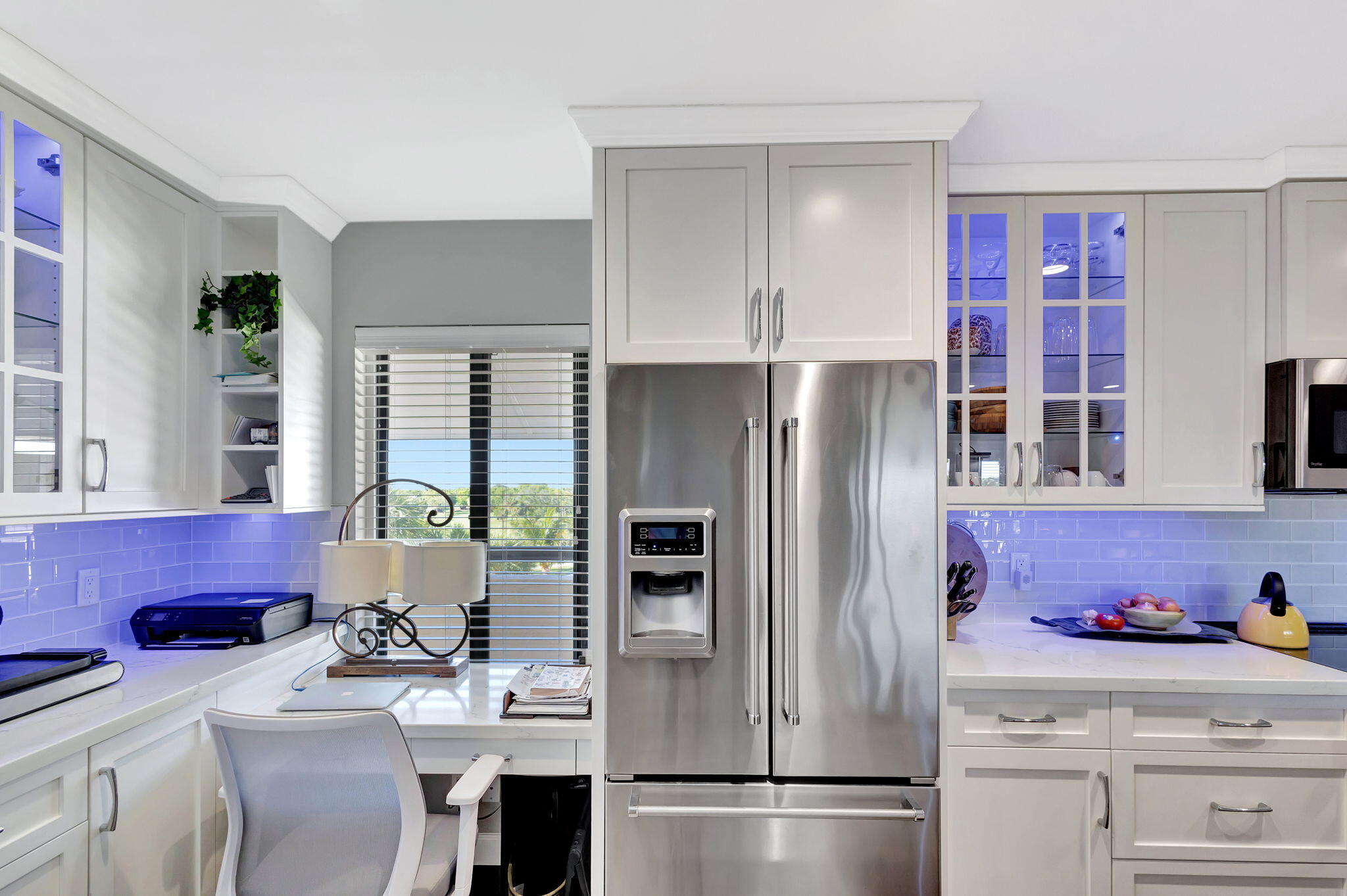 16910 Bay Street, Unit E503 Jupiter, FL 33477 - Photo 15 of 33 a kitchen with stainless steel appliances a refrigerator sink and cabinets