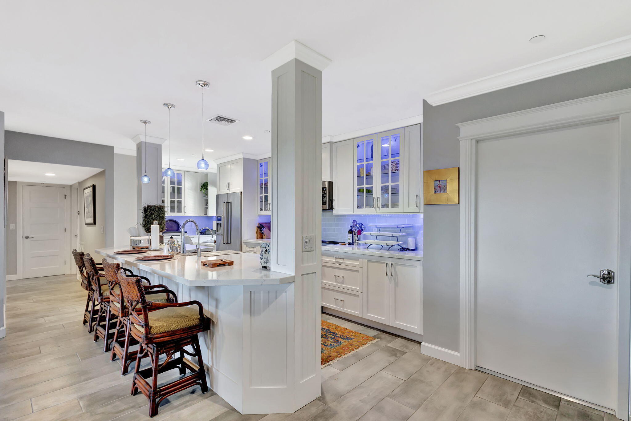 16910 Bay Street, Unit E503 Jupiter, FL 33477 - Photo 20 of 33 a view of a dining room with furniture and a chandelier