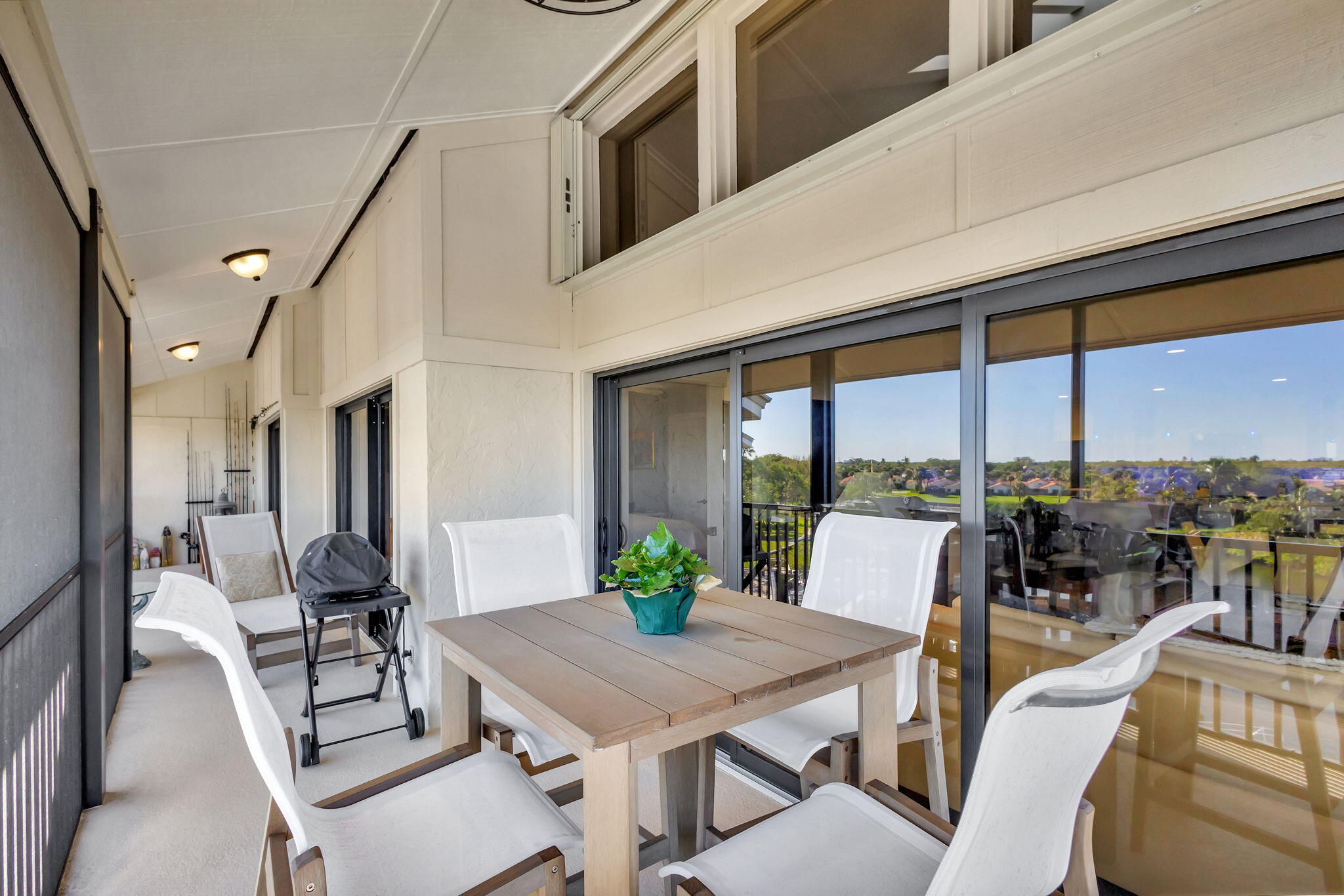 16910 Bay Street, Unit E503 Jupiter, FL 33477 - Photo 28 of 33 a view of a dining room with furniture large windows and wooden floor