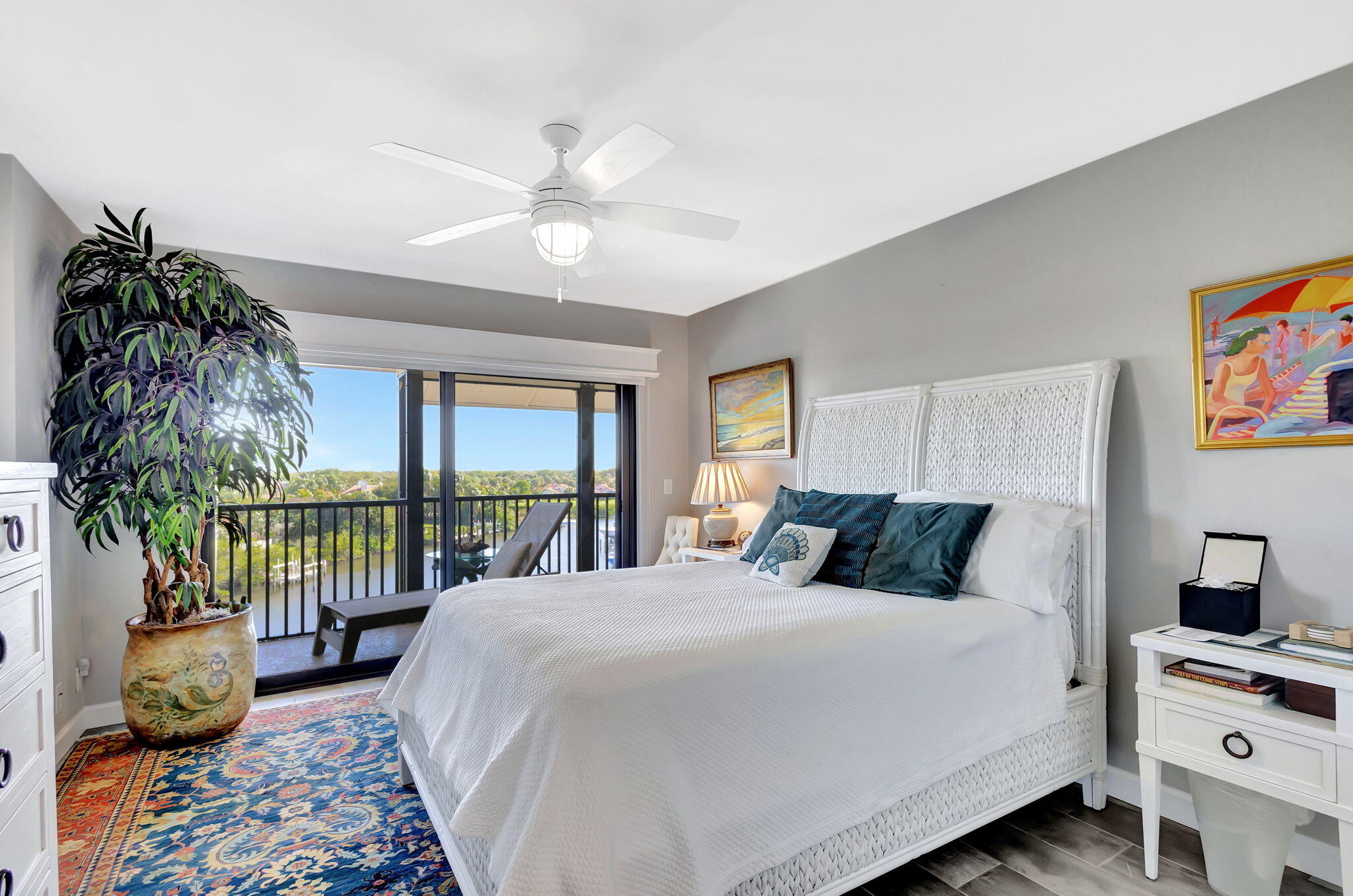 16910 Bay Street, Unit E503 Jupiter, FL 33477 - Photo 5 of 33 a bedroom with a bed and a chandelier